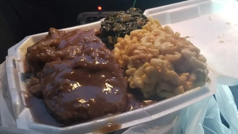 Homestyle Smithered Chops over White Rice & Gravy Mac & Cheese Greens